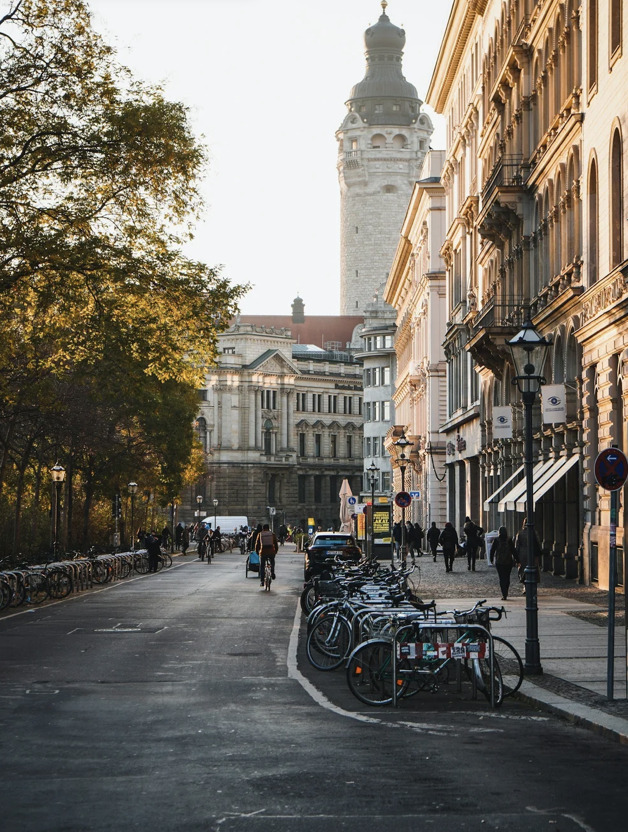 An autumn street in Leipzig leading to the New Town Hall tower